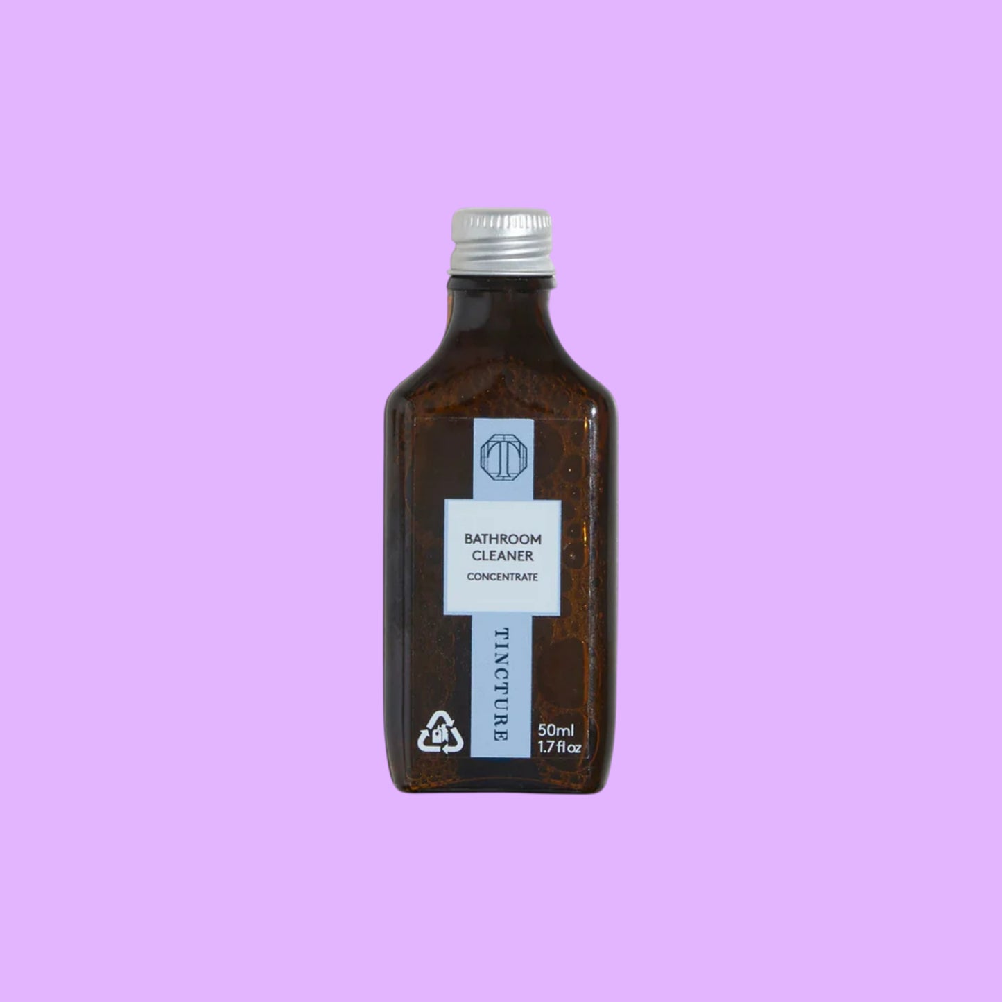 Tincture London 50ml bathroom cleaner concentrate in a small amber glass bottle with a silver cap.