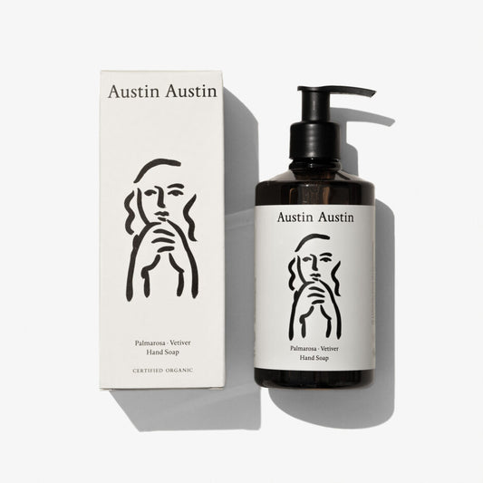 Austin Austin Palmarosa and Vetiver Hand Soap 300ml amber bottle with black pump dispenser alongside white FSC box, both featuring Indian ink artwork by Christian Newby, photographed from above on a white background