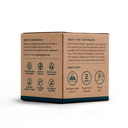 Georganics mineral toothpaste cardboard packaging with product information, icons, and directions on a white background.