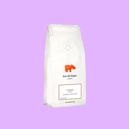 Kiss the Hippo organic whole bean coffee in a white nitrogen-flushed bag featuring a red hippo logo and Donna blend label (view 2).
