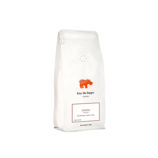 Coffee bag labeled 'kiss the hippo' on a white background