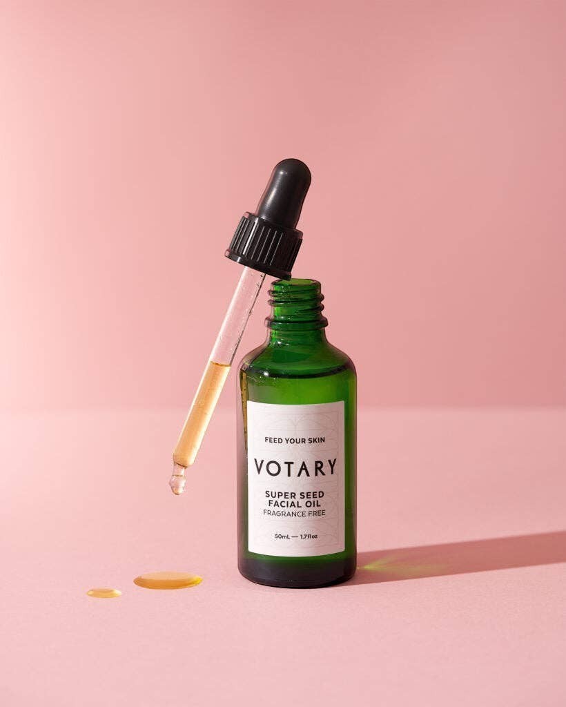 Votary Super Seed Facial Oil in a green glass bottle with a dropper, featuring a fragrance-free formula for skin.