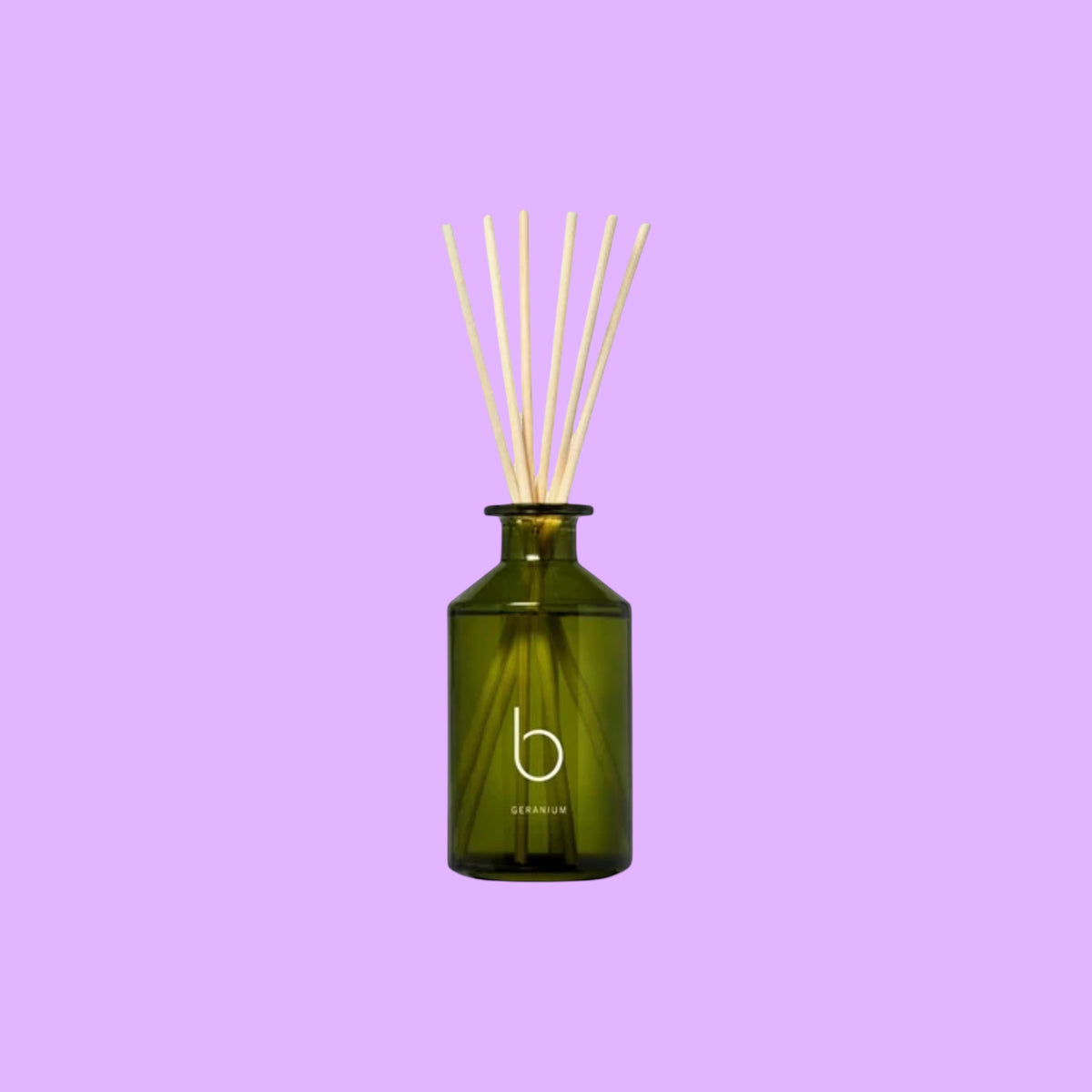 bamford Geranium reed diffuser in a green glass bottle with natural wooden reeds for home fragrance