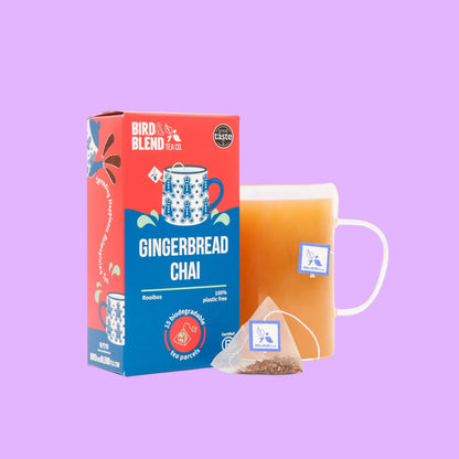 Bird and blend Gingerbread Chai tea box and a glass mug of brewed rooibos tea with a biodegradable pyramid tea bag