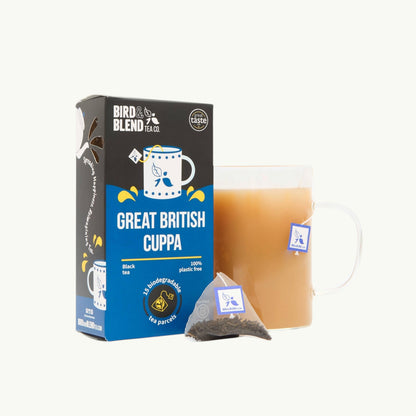 Bird and Blend Great British Cuppa black tea box with a glass mug of brewed tea and a plastic-free biodegradable tea bag