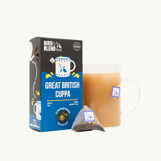 Bird and Blend Great British Cuppa black tea box with a glass mug of brewed tea and a plastic-free biodegradable tea bag