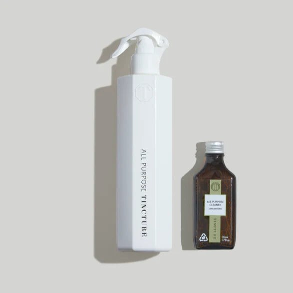 Tincture London all purpose cleaner starter kit with a white reusable spray bottle and concentrated refill, in a lifestyle setting.