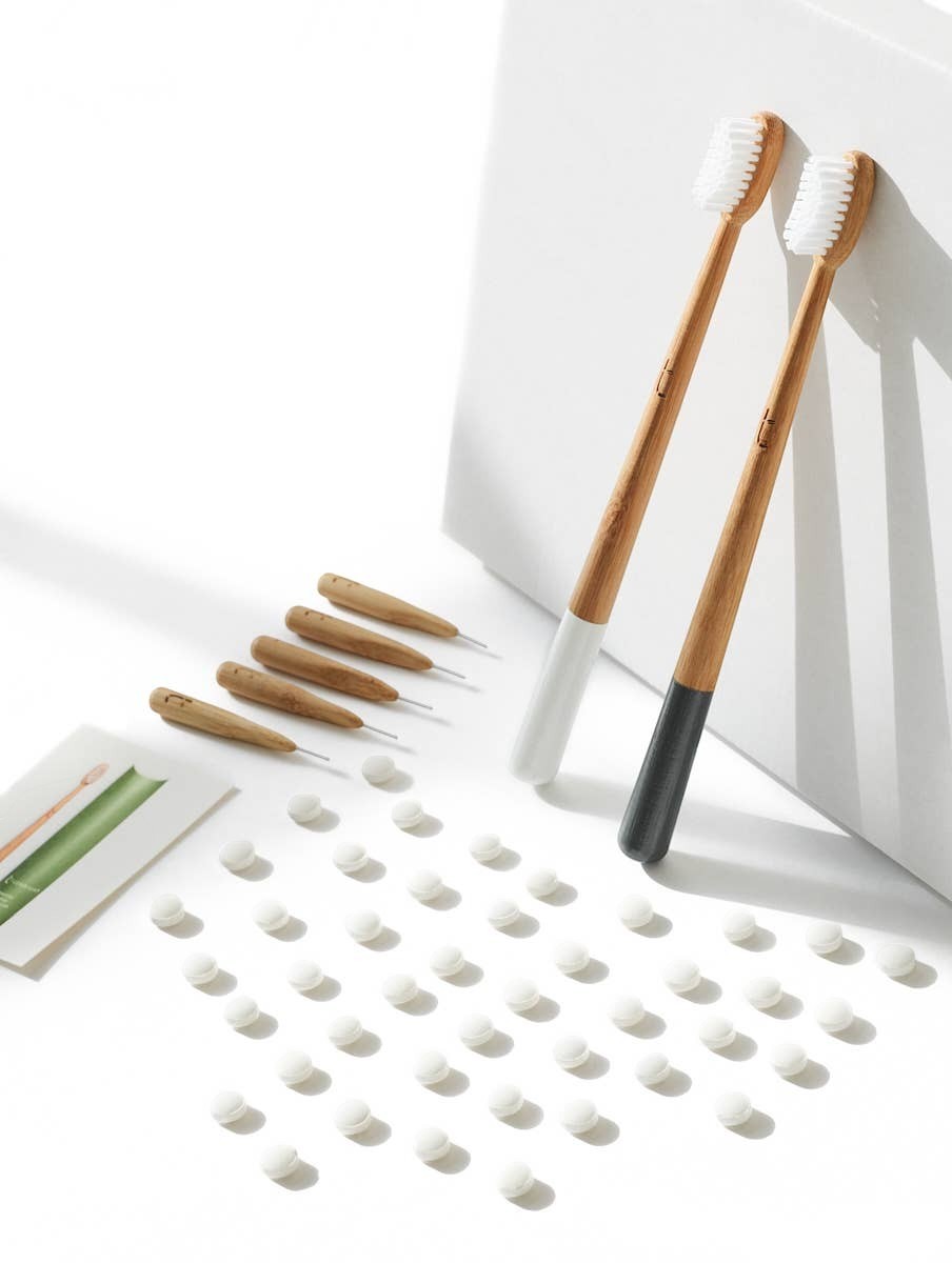 Truthbrush bamboo interdental brushes with nylon bristles and two full-sized bamboo toothbrushes on a white background.