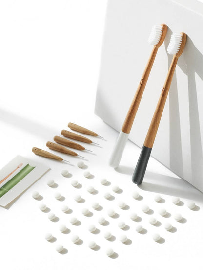 Truthbrush bamboo interdental brushes with nylon bristles and two full-sized bamboo toothbrushes on a white background.