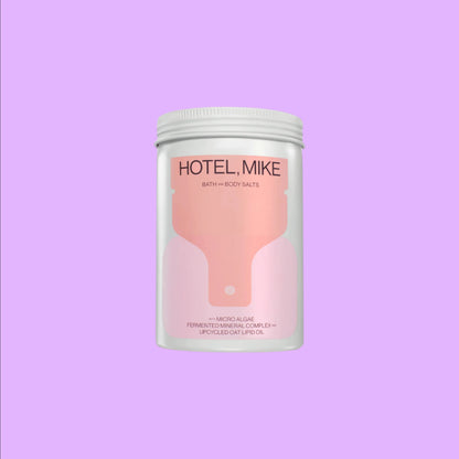 Hotel Mike Bath + Body Salts in a recyclable jar featuring upcycled oat lipid oil and fermented mineral complex ingredients.