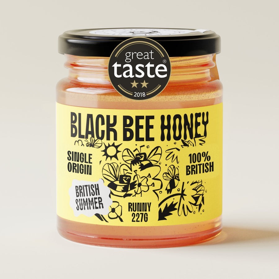 BRiMM Black Bee Honey Raw British Summer runny honey in a glass jar with a yellow label and Great Taste award sticker.