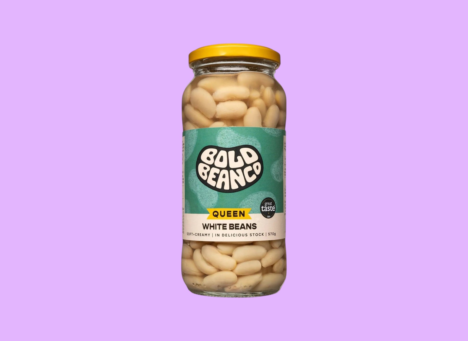 Bold Bean Co Queen white beans in a 570g glass jar with a yellow lid and green label, shown from a different angle.