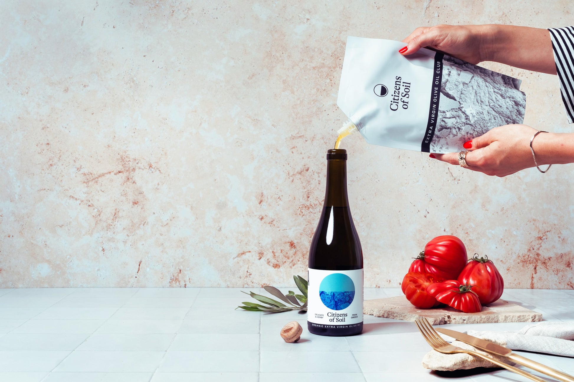 BRiMM Citizens of Soil organic Greek extra virgin olive oil being poured from a pouch into a glass bottle