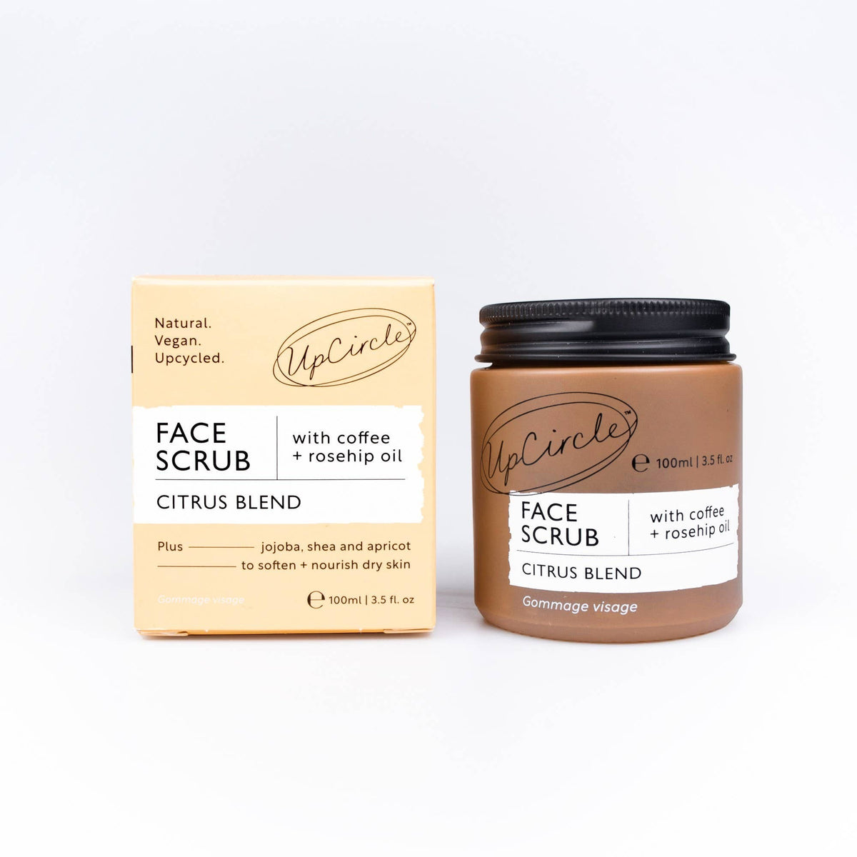 UpCircle face scrub with coffee and rosehip oil in a brown glass jar next to its beige recyclable cardboard box.