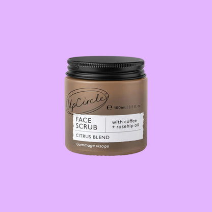 UpCircle face scrub in a brown glass jar with a black aluminium lid, featuring coffee and rosehip oil ingredients, shown from a different angle.