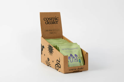 Cosmic Dealer pistachio and lion's mane dark chocolate bars in a branded cardboard display box