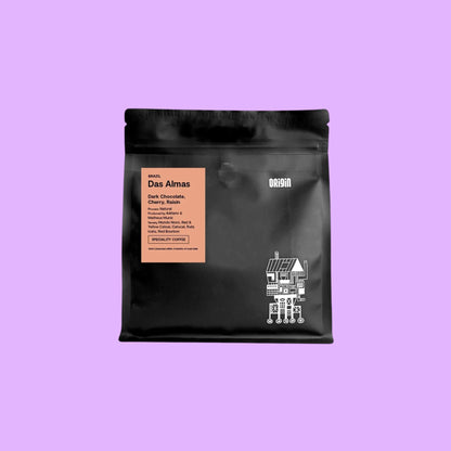 Origin Coffee Das Almas whole bean coffee in a black 250g bag with a pink label featuring tasting notes of chocolate and cherry