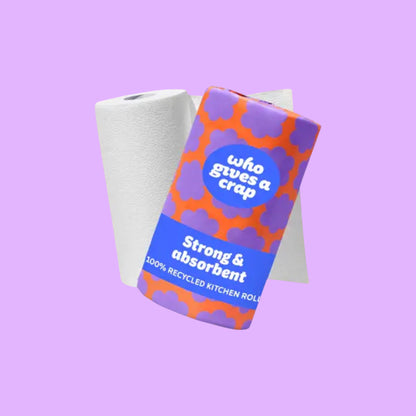 Who Gives A Crap double length 2-ply kitchen roll in orange and purple patterned paper wrapping, shown from a different angle.