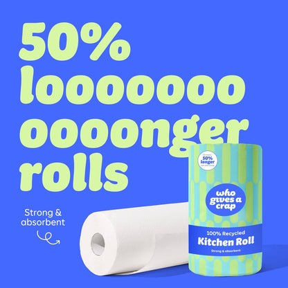 Who Gives A Crap double length 2-ply kitchen roll in green patterned paper packaging next to a white paper towel roll