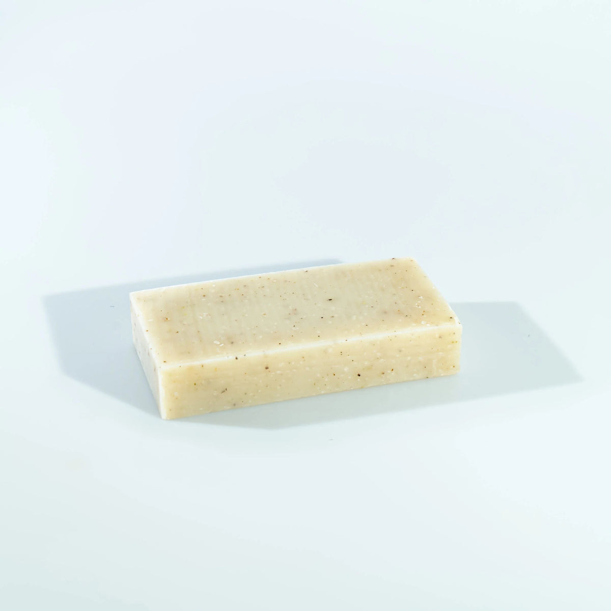 dulcie exfoliating seaweed block soap with a natural beige texture and visible botanical inclusions