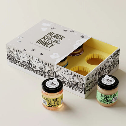 Black Bee Honey Four Seasons Mini Honey Gift Box featuring four single-origin British honey jars in an illustrated box