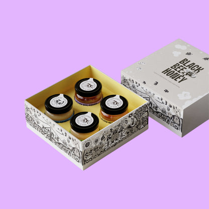 Black Bee Honey Four Seasons mini honey gift box featuring four distinct British single-origin honey jars in illustrated packaging