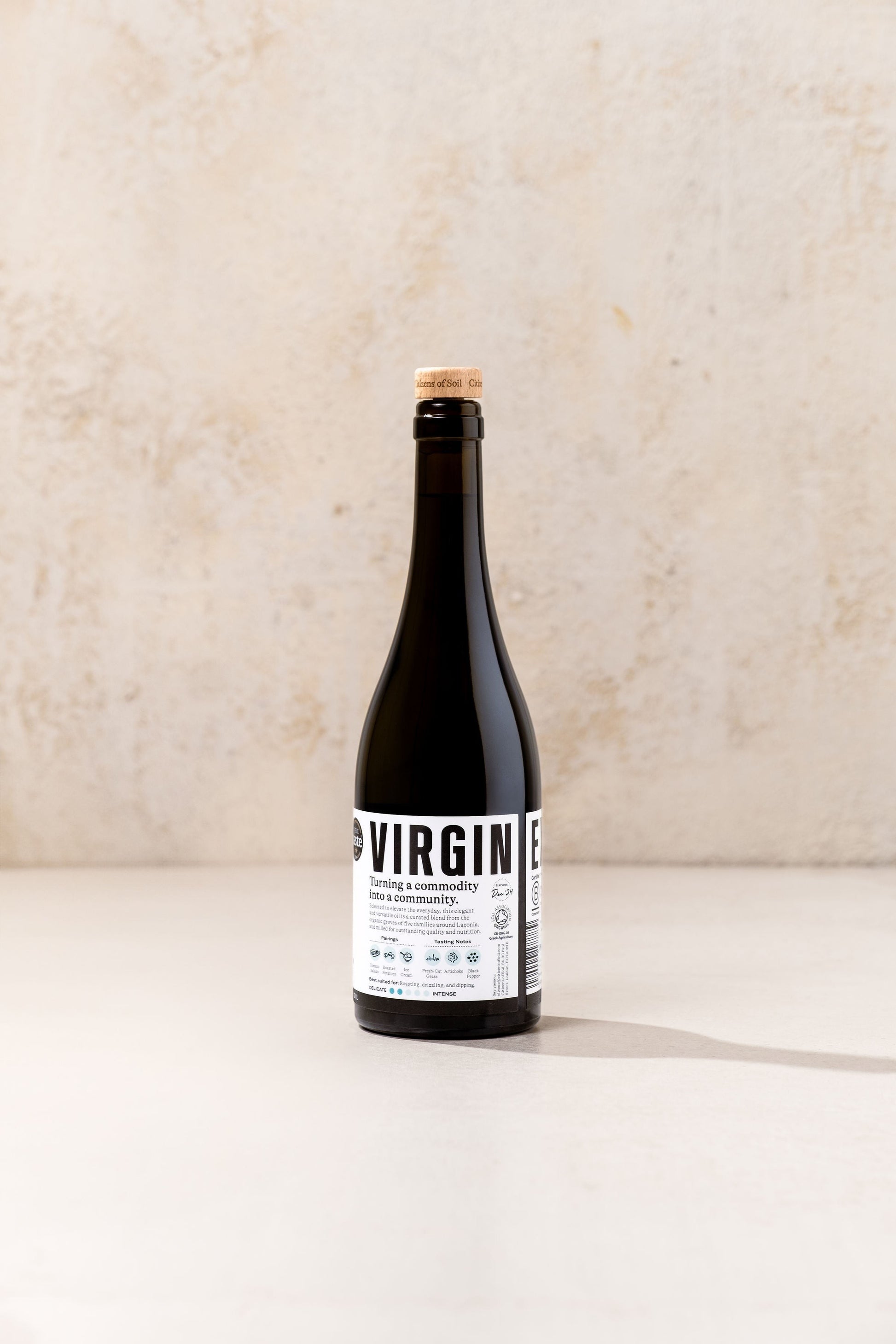 BRiMM Citizens of Soil organic Greek extra virgin olive oil in a dark glass bottle with a cork stopper.