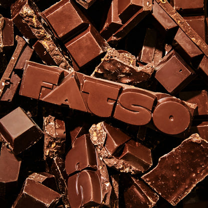 Fatso Home Run dark chocolate slab with pretzel, honeycomb, and almond inclusions in a chunky, broken format.