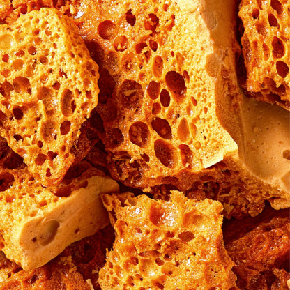 Fatso Home Run dark chocolate bar featuring crunchy honeycomb pieces and whole almonds in a close-up texture shot.
