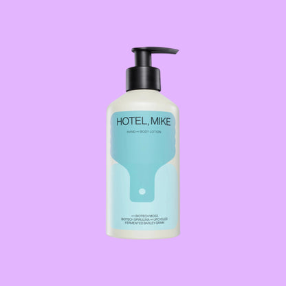 Hotel, Mike hand and body lotion in a sustainable aluminium bottle with a black pump dispenser, shown from a different angle.