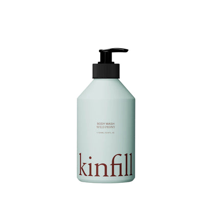 Kinfill refillable body wash bottle in pale green with a black pump dispenser and minimalist branding