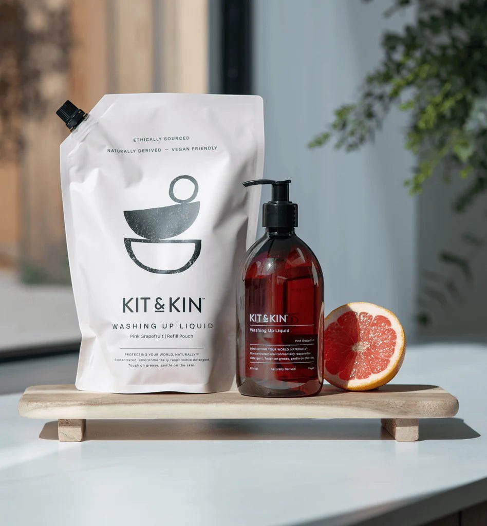Kit & Kin eco-friendly grapefruit and orange washing-up liquid with refill pouch and pump bottle on wood tray