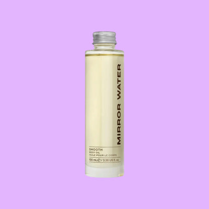 Mirror Water Smooth body oil in a 100ml glass bottle with a silver cap, featuring a woody and citrus scent.