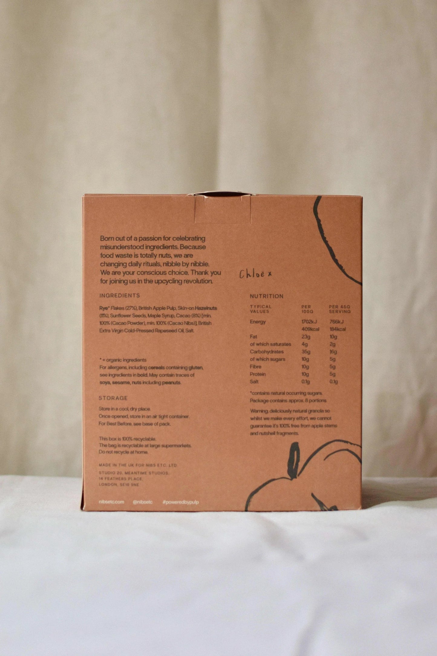 Nibs Etc. granola packaging back view showing ingredients, nutrition facts, and upcycled apple pulp details.
