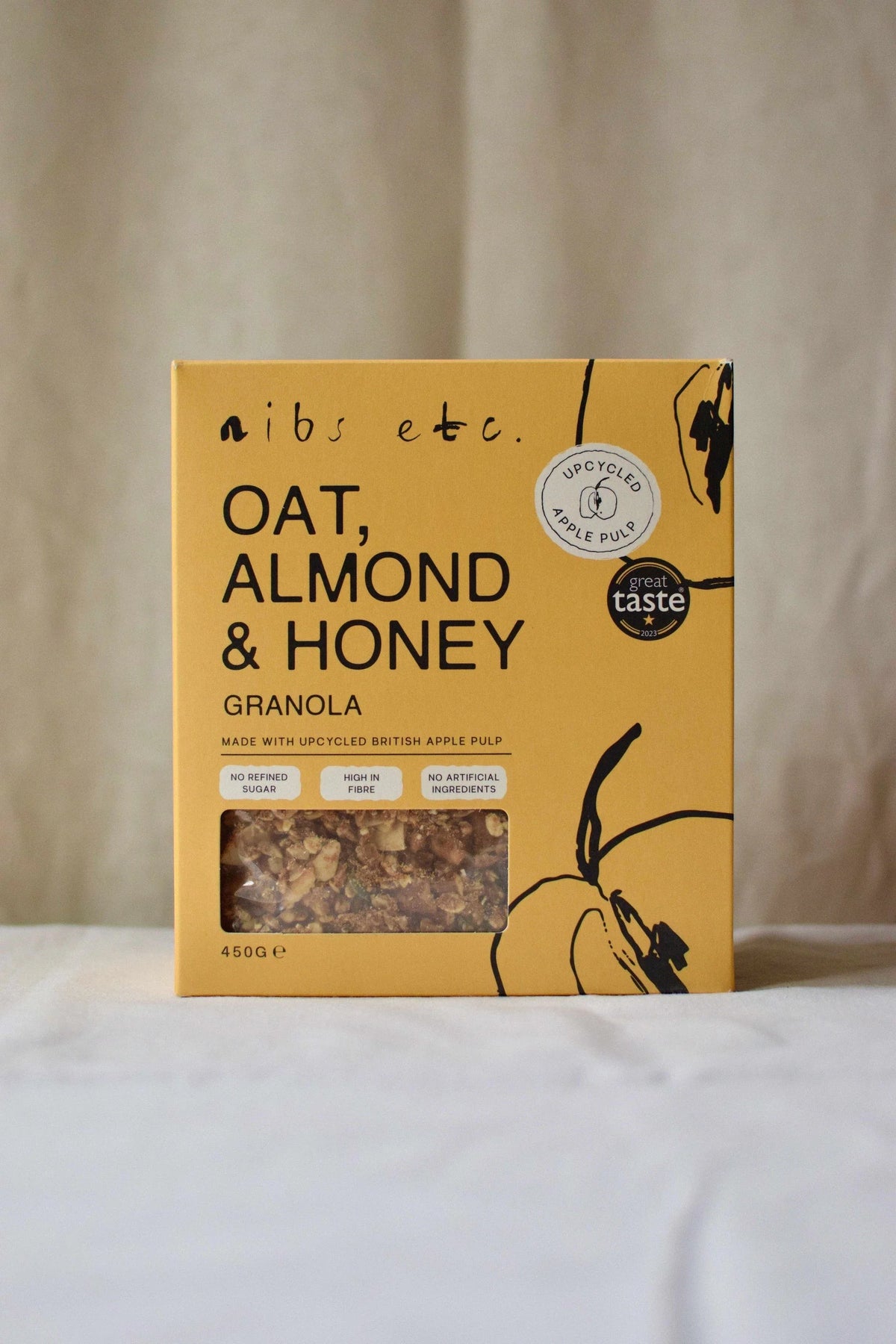 Nibs Etc. Oat, Almond & Honey Granola in a yellow box made with upcycled apple pulp and high fibre ingredients.