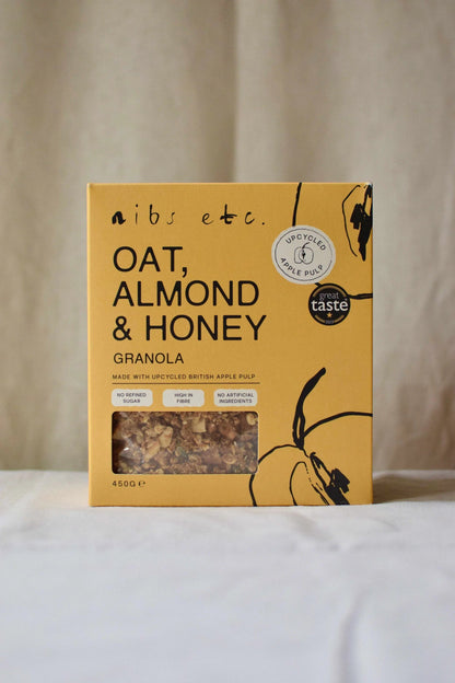 Nibs Etc. Oat, Almond & Honey Granola in a yellow box made with upcycled apple pulp and high fibre ingredients.