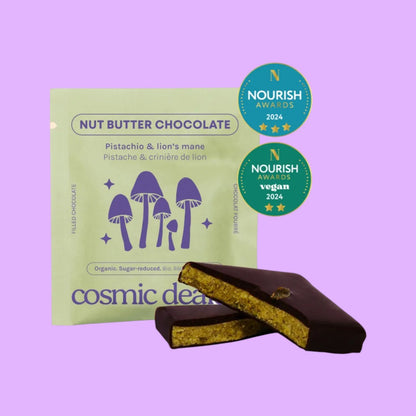 Cosmic Dealer pistachio and lion's mane dark chocolate bar with a nut butter center and Nourish Award stickers.