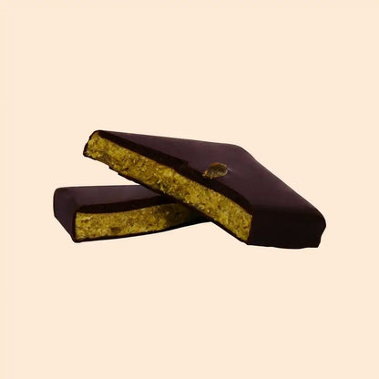 Cosmic Dealer dark chocolate bar with a pistachio nut butter center and Lion's Mane mushroom extract, split in half