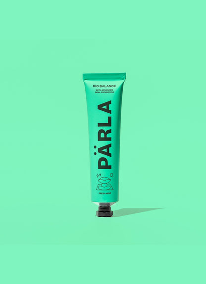 Pärla Probiotic Toothpaste in a mint green tube with black text, designed for fresh breath and oral health.