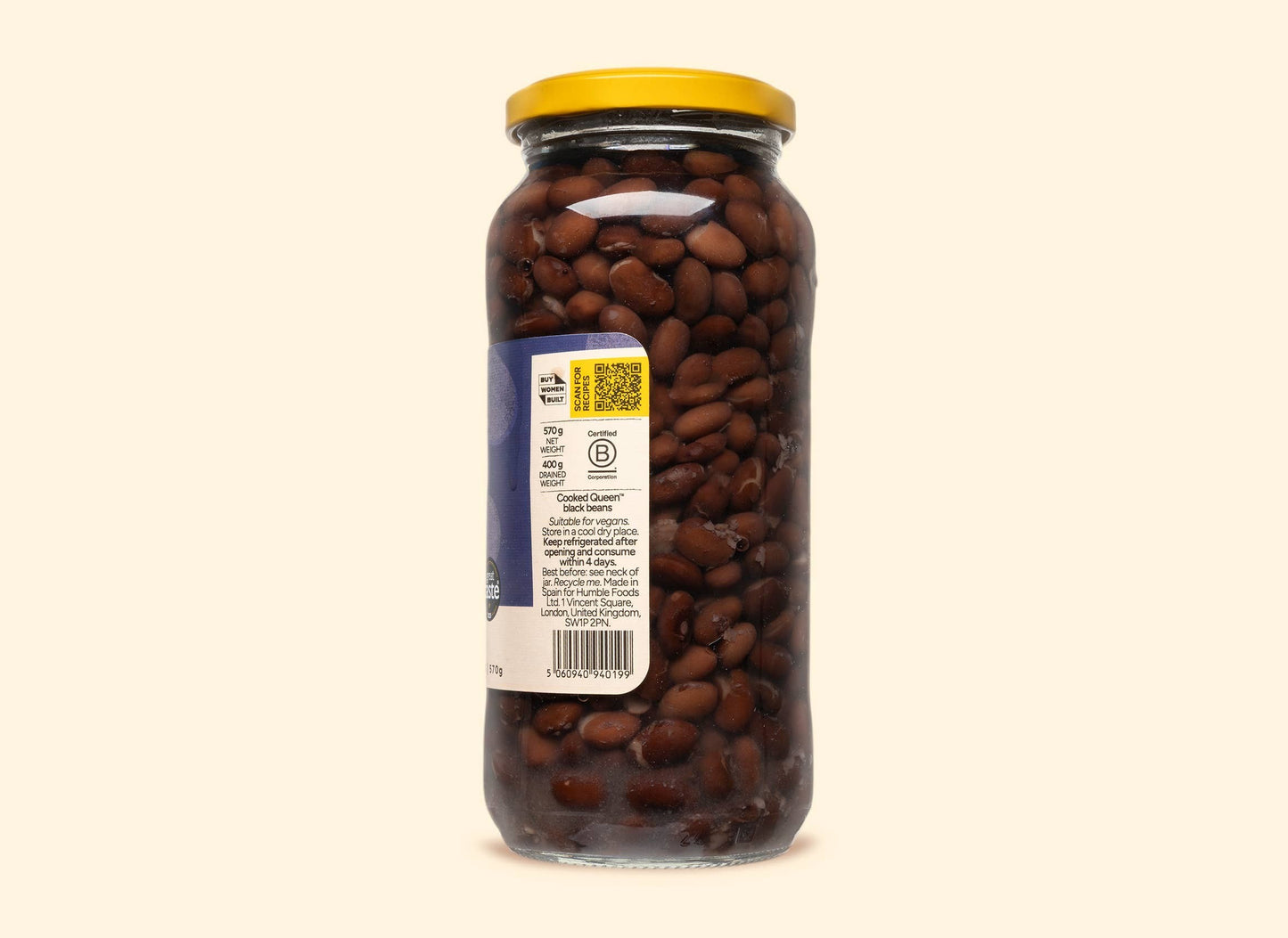 Bold Bean Co Queen Black Beans in a 570g glass jar with a yellow lid, showing the product label and dark cooked beans.