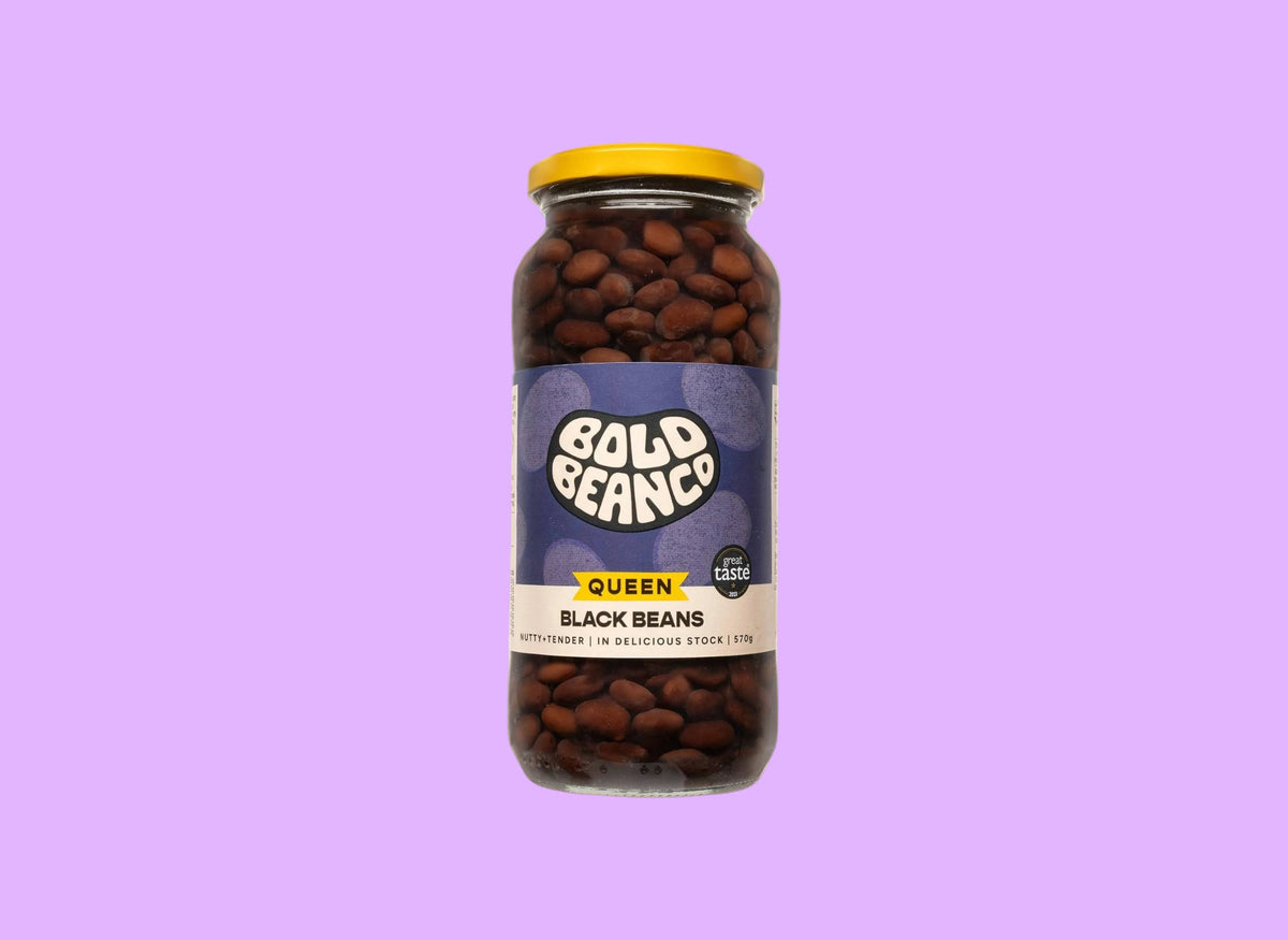 Bold Bean Co Queen Black Beans in a 570g glass jar with a yellow lid and purple label featuring Bold Bean Co branding.