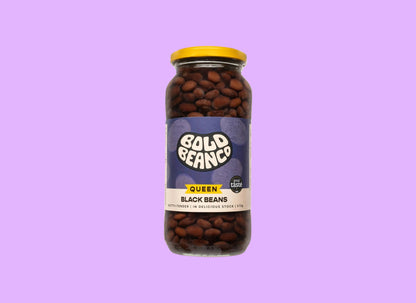 Bold Bean Co Queen Black Beans in a 570g glass jar with a yellow lid and purple label featuring Bold Bean Co branding.