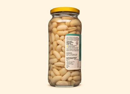 Bold Bean Co Queen white beans in a 570g glass jar with a yellow lid, showing nutritional information and product details.