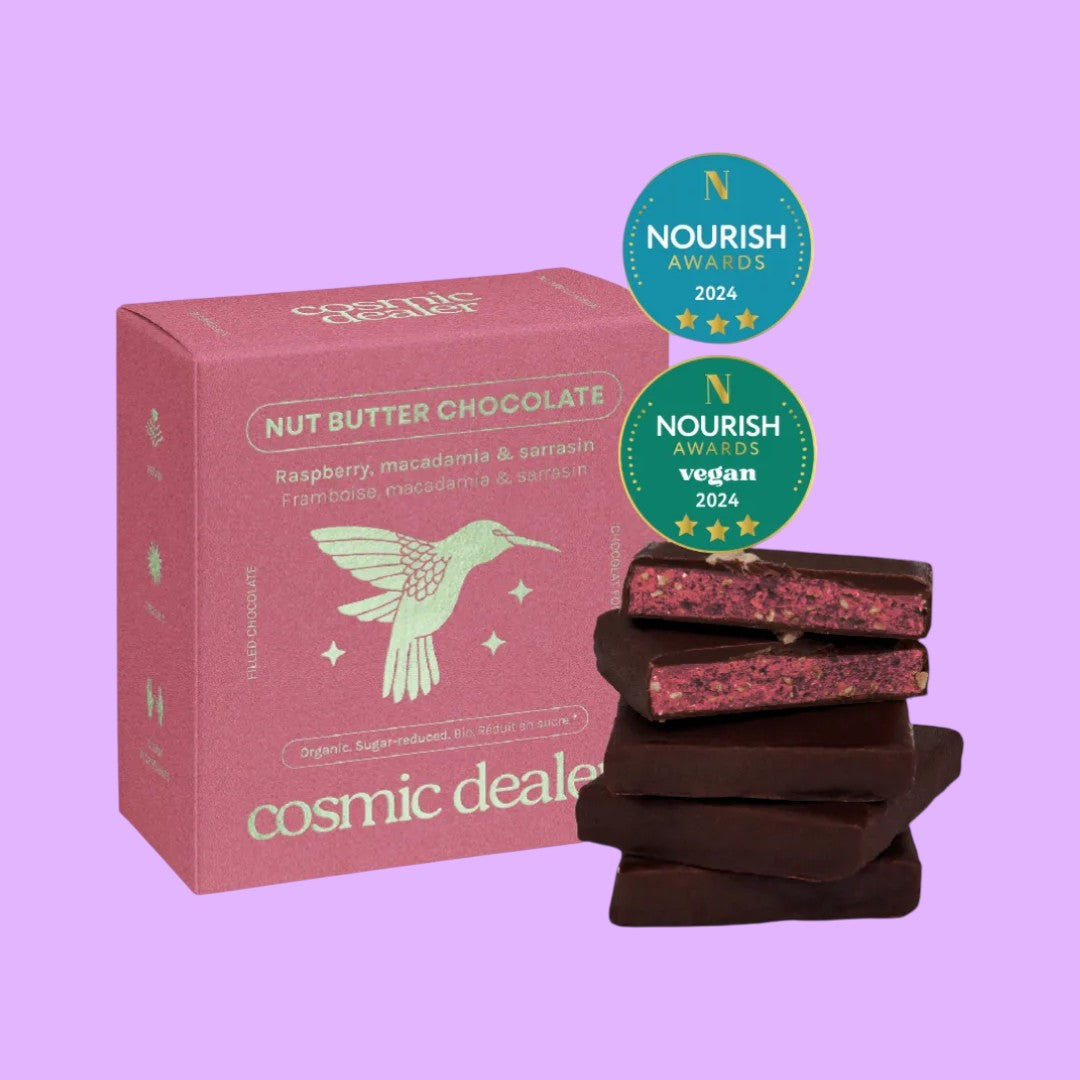 Cosmic Dealer Nut Butter Chocolates Raspberry with macadamia and 75% dark cacao, shown with packaging and stacked squares.