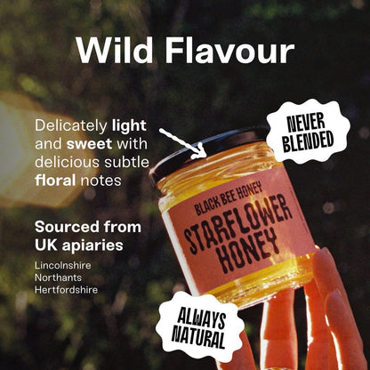 Black Bee Honey Raw Starflower Honey jar held in hand with light golden texture and floral flavour description
