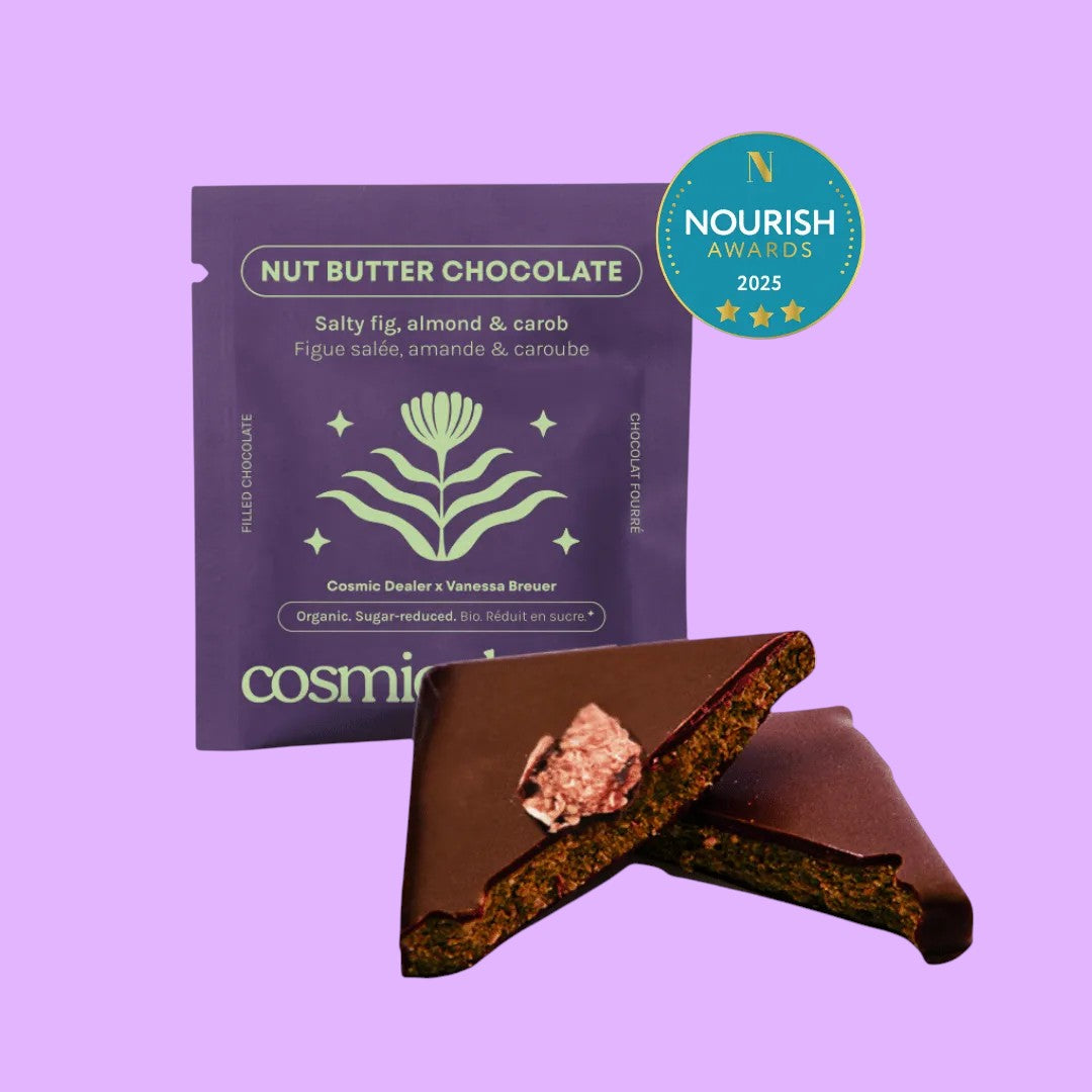 Cosmic Dealer Salty Fig chocolate bar with almond butter and carob, featuring a purple wrapper and a broken piece of chocolate (view 2).