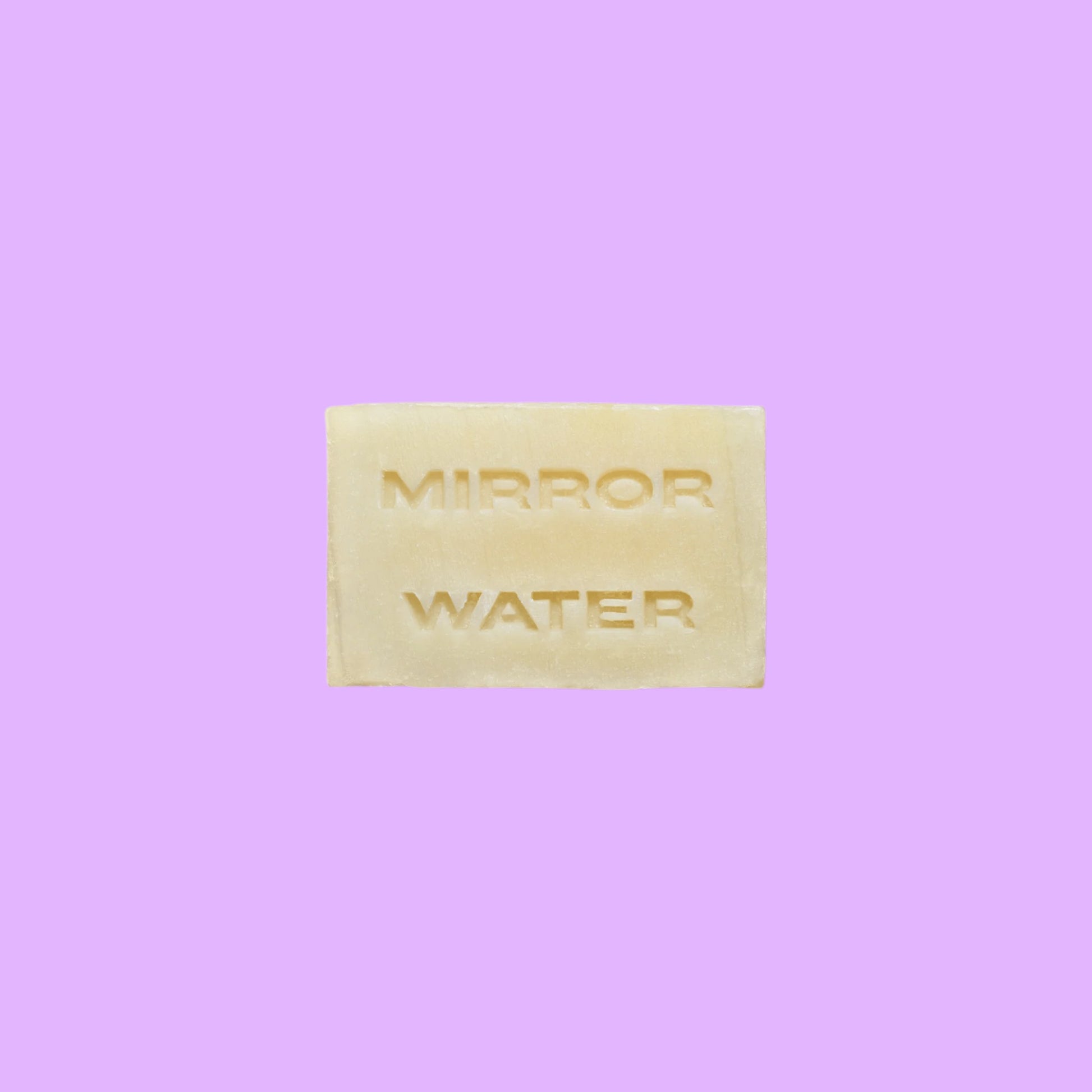 Mirror Water Shea Butter Brick solid face and body cleanser bar with embossed lettering on a neutral background