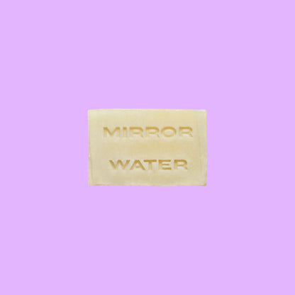 Mirror Water Shea Butter Brick solid face and body cleanser bar with embossed lettering on a neutral background