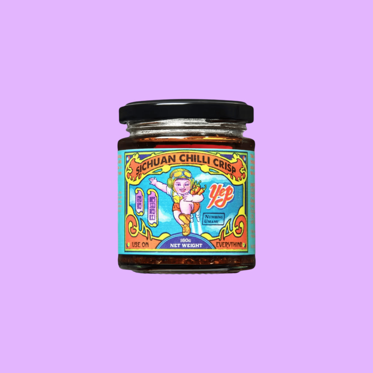 Yep Kitchen Sichuan Chilli Crisp oil in a glass jar with a colourful illustrated label featuring a cartoon character, shown from a different angle.