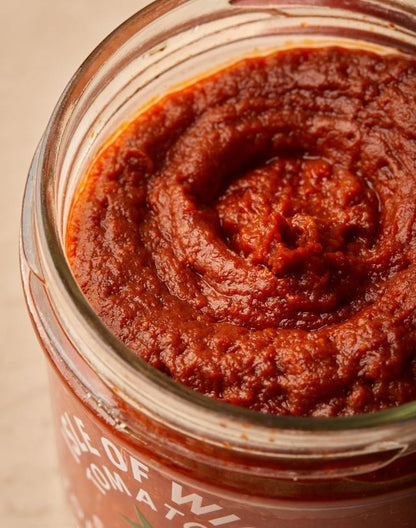 Isle of Wight Tomatoes Smoked Tomato Pesto in a glass jar, featuring a rich red texture made with roasted Isle of Wight tomatoes.